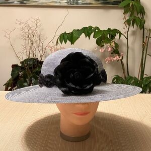Elegant Black and White  Hat With Black Wavy Band and Black Floral Accent